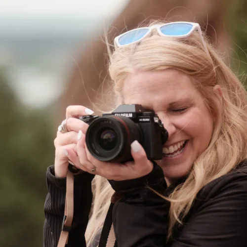 Abbey with a camera smiling at Red Rocks Ampitheater