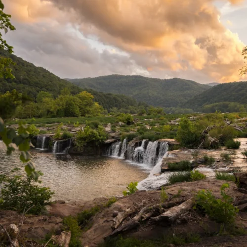 the waterfalls at Sandstone Falls cast in golden evening light