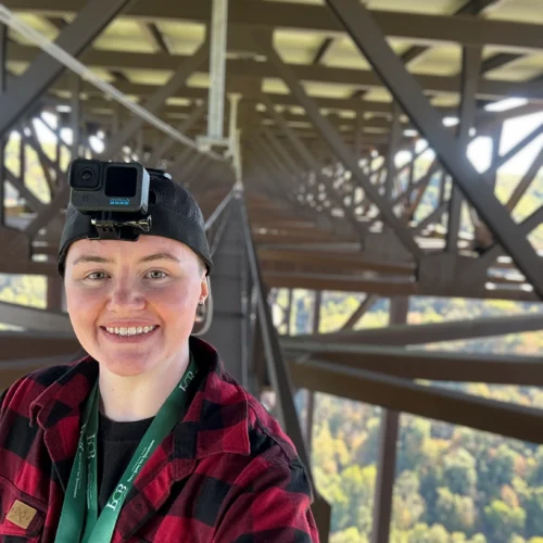 Caitlynn on the catwalk of the New River Gorge Bridge with a GoPro