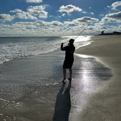 Caitlynn fly fishing on the beach at Ocean Isle