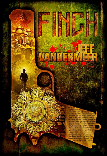 Book cover for "Finch" by Jeff VanderMeer, shaped like a revolver silhouette, with a gilded fungal growth on the grip, a tiny figure walking toward an ornate glowing city on the barrel, red blood spatter across a green weathered background, and a partial page of text visible at the edge.