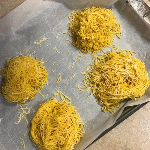 Homemade pasta on a baking sheet