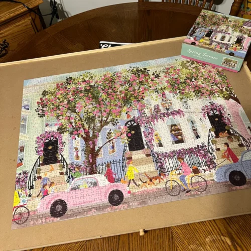 a completed puzzle featuring a spring scene of a downtown block of townhomes