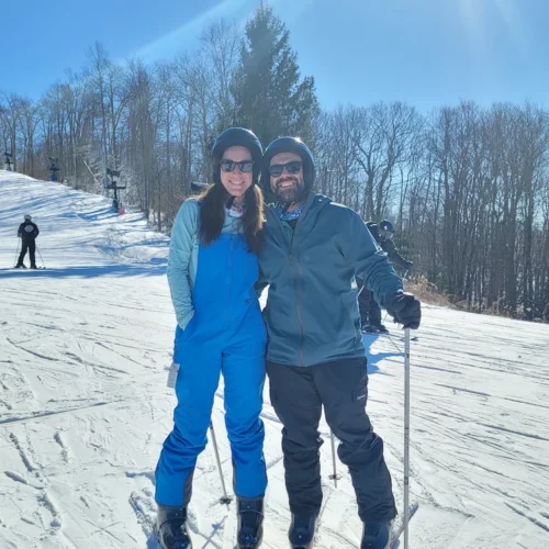 Hilary and partner standing on skis