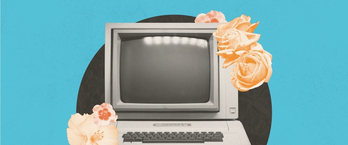 Vintage retro computer monitor with keyboard, surrounded by peach roses on a teal background.