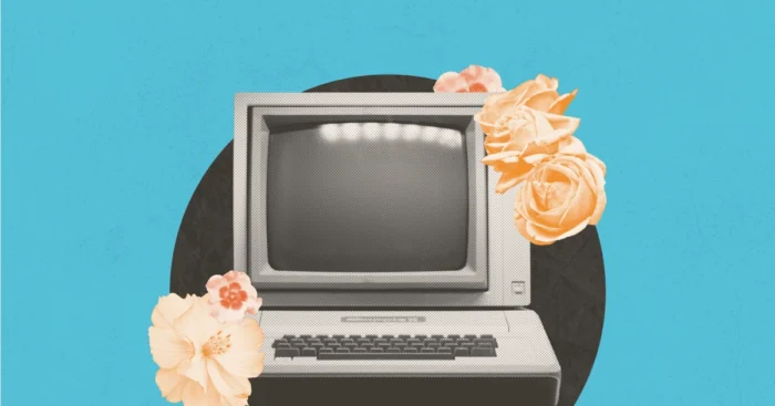 Vintage retro computer monitor with keyboard, surrounded by peach roses on a teal background.
