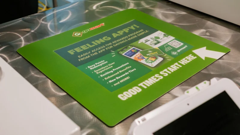 GoMart branded counter mats at the Charleston Civic Center Grab N' Go Register location.

The counter mats show the viewer how to apply to the GoMart rewards program - featuring helpful instructions, a QR code to download the GoMart app.