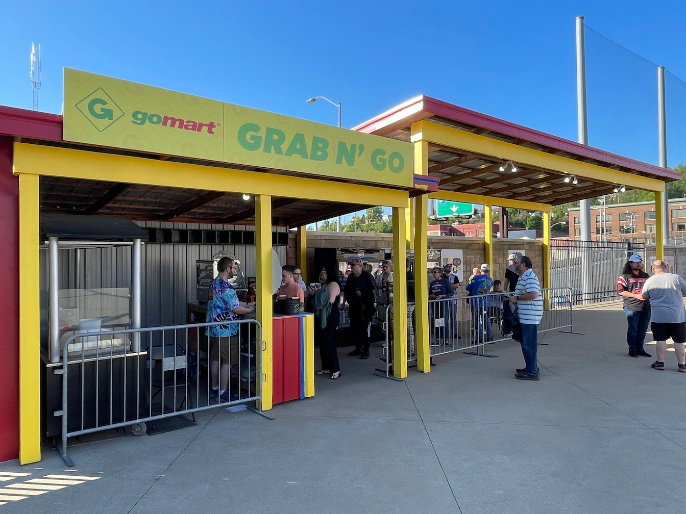 The GoMart Grab N' Go Location at the GoMart Ballpark - home of the Charleston Dirty Birds.

A group of people are lined up at the counter, waiting to purchase their drinks from the concessions workers.