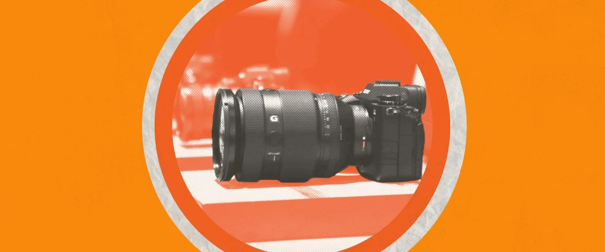 A row of cameras on a dark orange circle against a light orange background