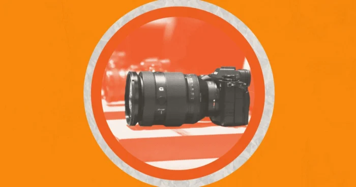 A row of cameras on a dark orange circle against a light orange background