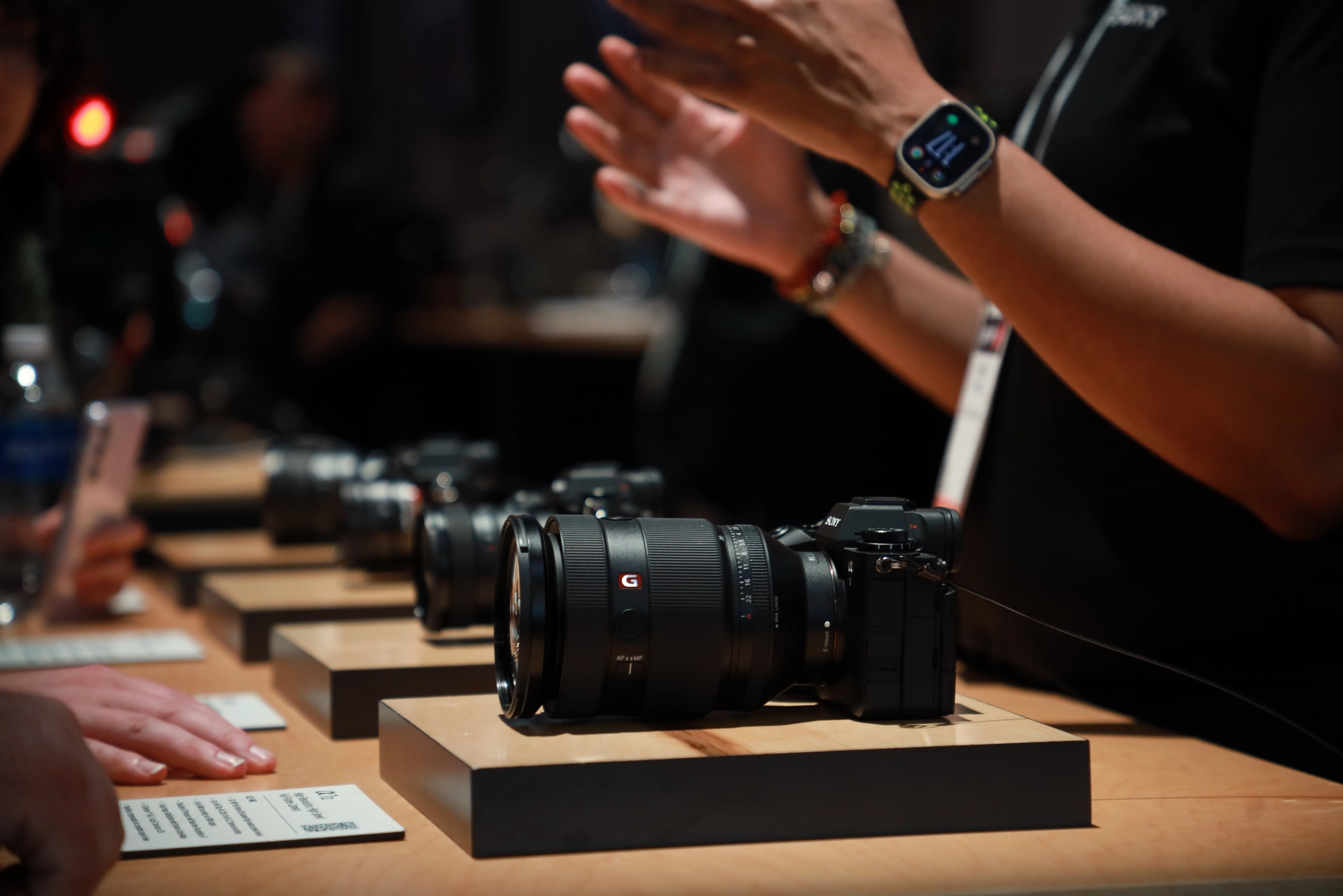 Photo at the Sony booth featuring their camera line and lenses.