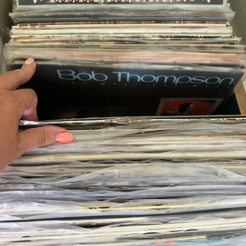 Vasilia's left hand digging through a crate of records. Pictured here is a record for West Virginia Music Hall of Fame Inductee, Bob Thompson