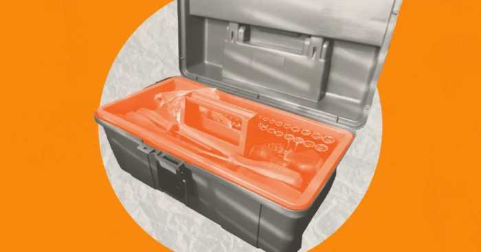 A tool box open to reveal a bright orange interior on a white circle against a light orange background