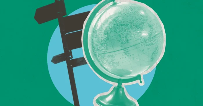 A globe and road sign on blue circle against a green background