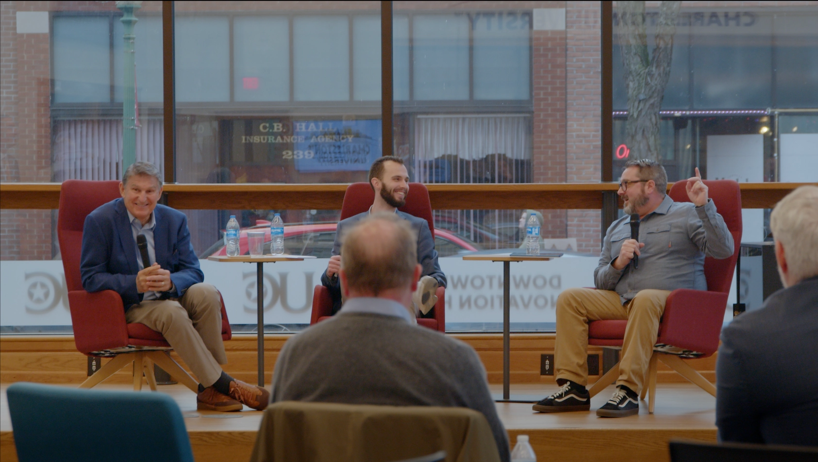 Pat Strader laughs with other speakers during a fireside chat at the University of Charleston