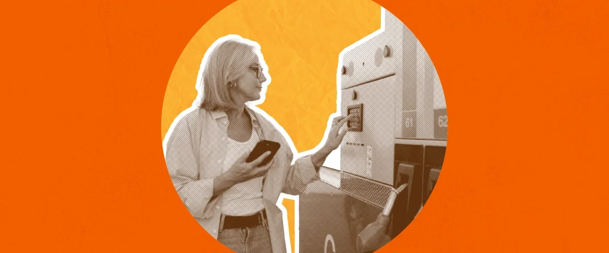 Woman using a kiosk or ATM machine while holding a smartphone, depicted in monochrome against an orange background.