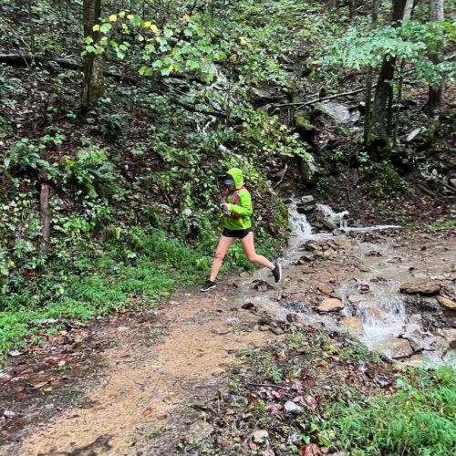 Hannah running in heavy rain during her first half marathon